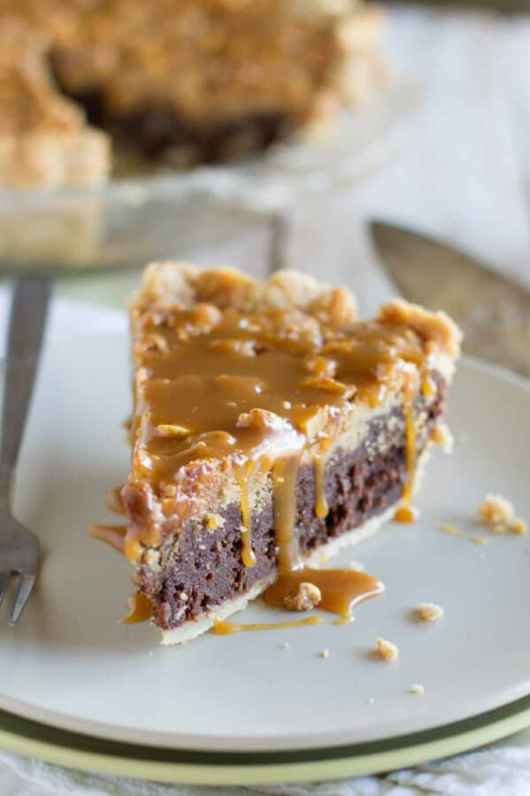 slice of peanut butter fudge pie topped with salted peanut butter caramel.