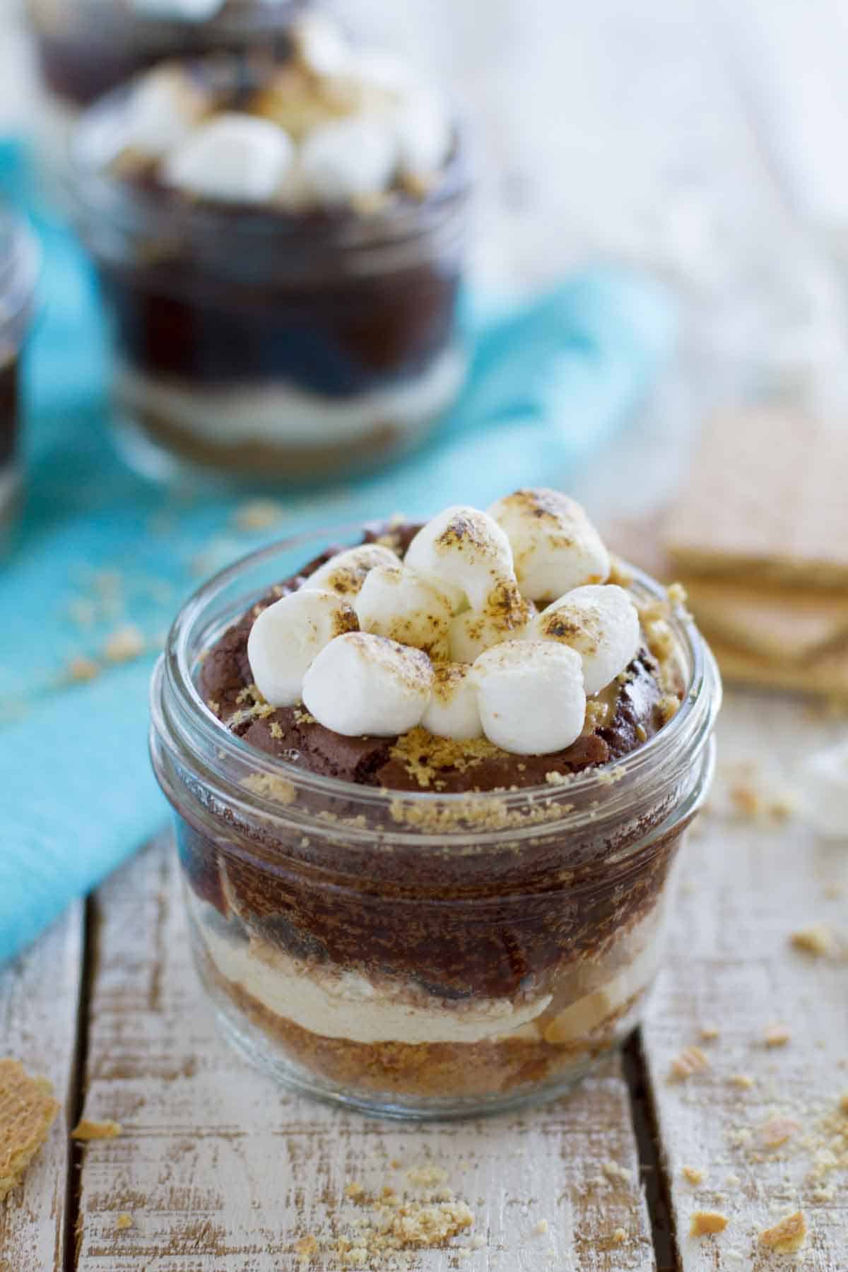 S’mores without the campfire! These Peanut Butter S’mores have a graham cracker crust, lots of marshmallow, rich chocolate and a peanut butter drizzle – all served in a jar. Peanut Butter S'mores with marshmallows and graham crackers