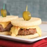 slider sized burgers topped with pimiento cheese and a pickle