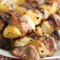 close up of grilled pineapple and pork kabobs