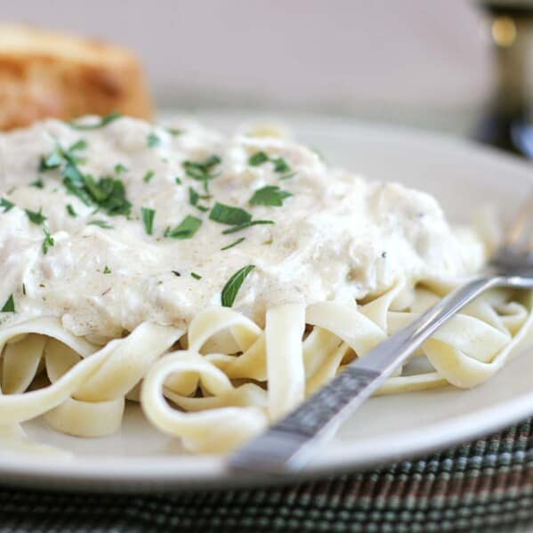 Slow Cooker Chicken Fettuccine on a plate topped with parsley