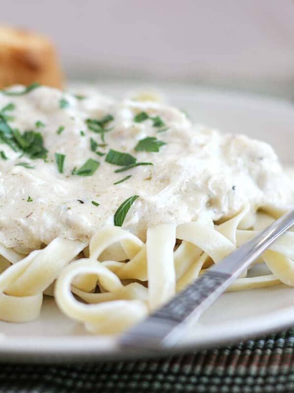 Slow Cooker Chicken Fettuccine on a plate topped with parsley