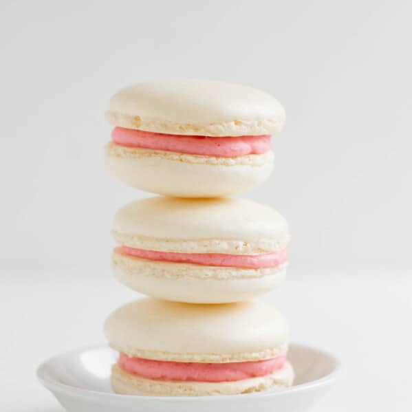 stack of three strawberry colada macarons.