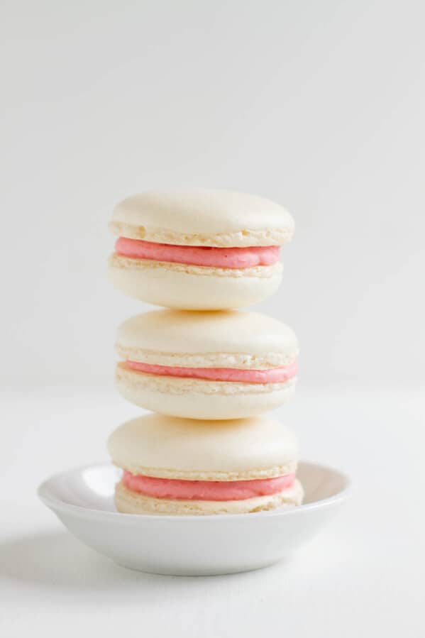 stack of three strawberry colada macarons.