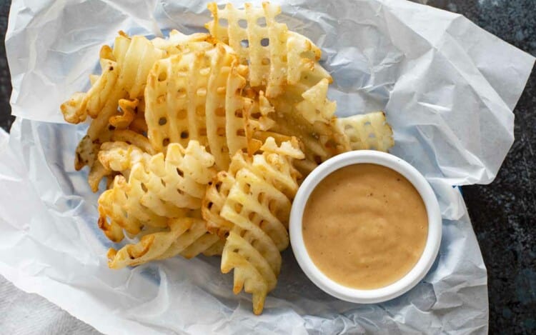 Basket with waffle fries and chick fil a sauce