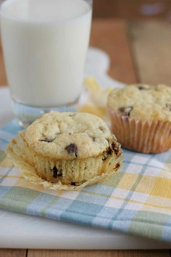 Chocolate Chip Sour Cream Muffins on a towel with the paper liner removed from one.