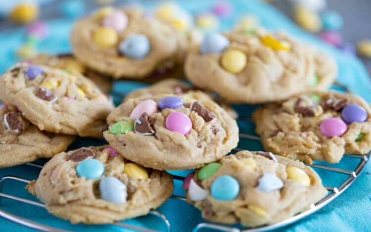 Easter cookies stacked on a cooling rack