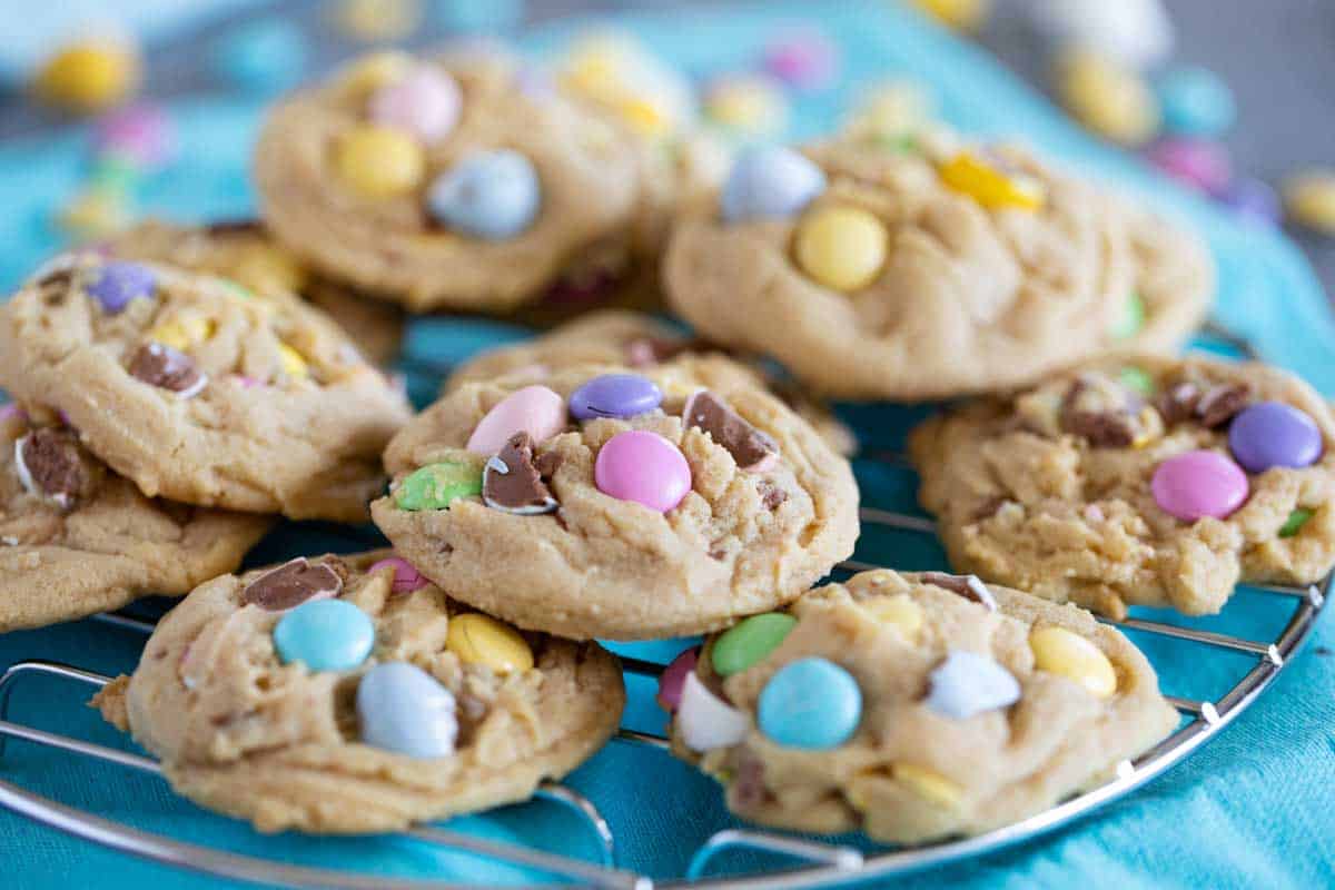 Easter cookies stacked on a cooling rack