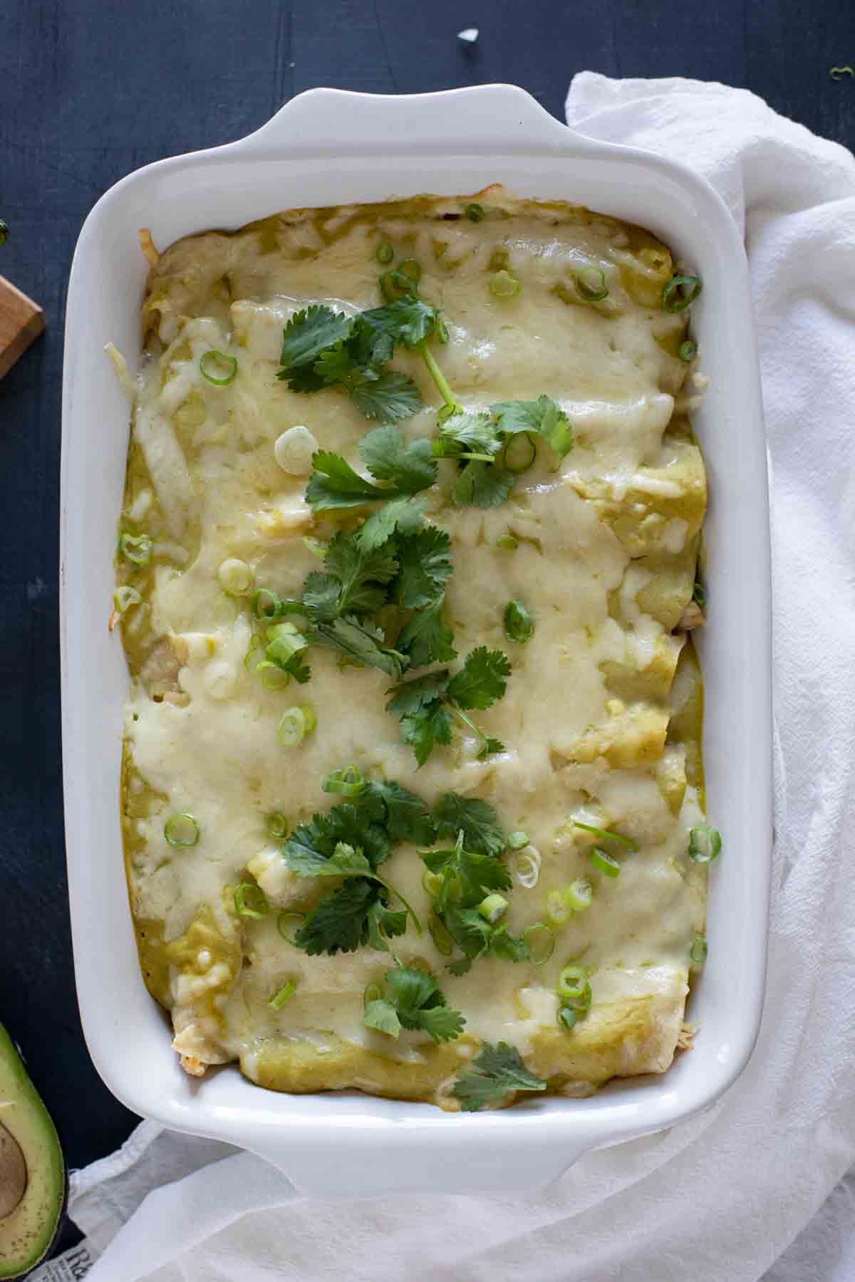 Green Chicken Enchiladas topped with onions and cilantro