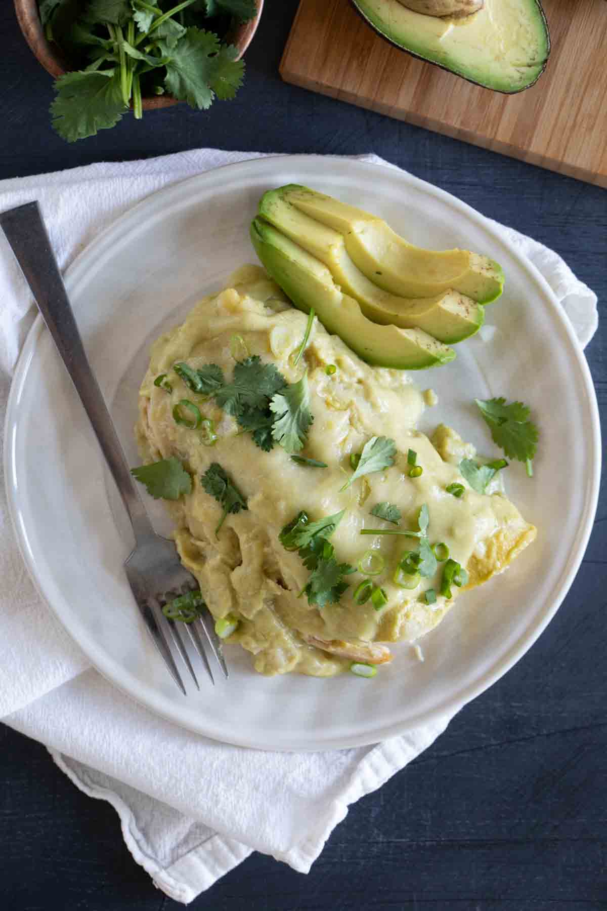 Green Chicken Enchiladas with avocado on the side