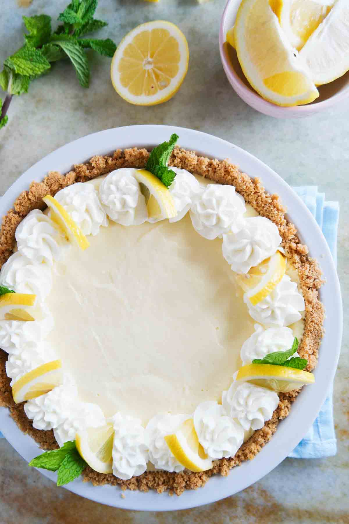 whole lemon cream pie with whipped cream and lemon slices