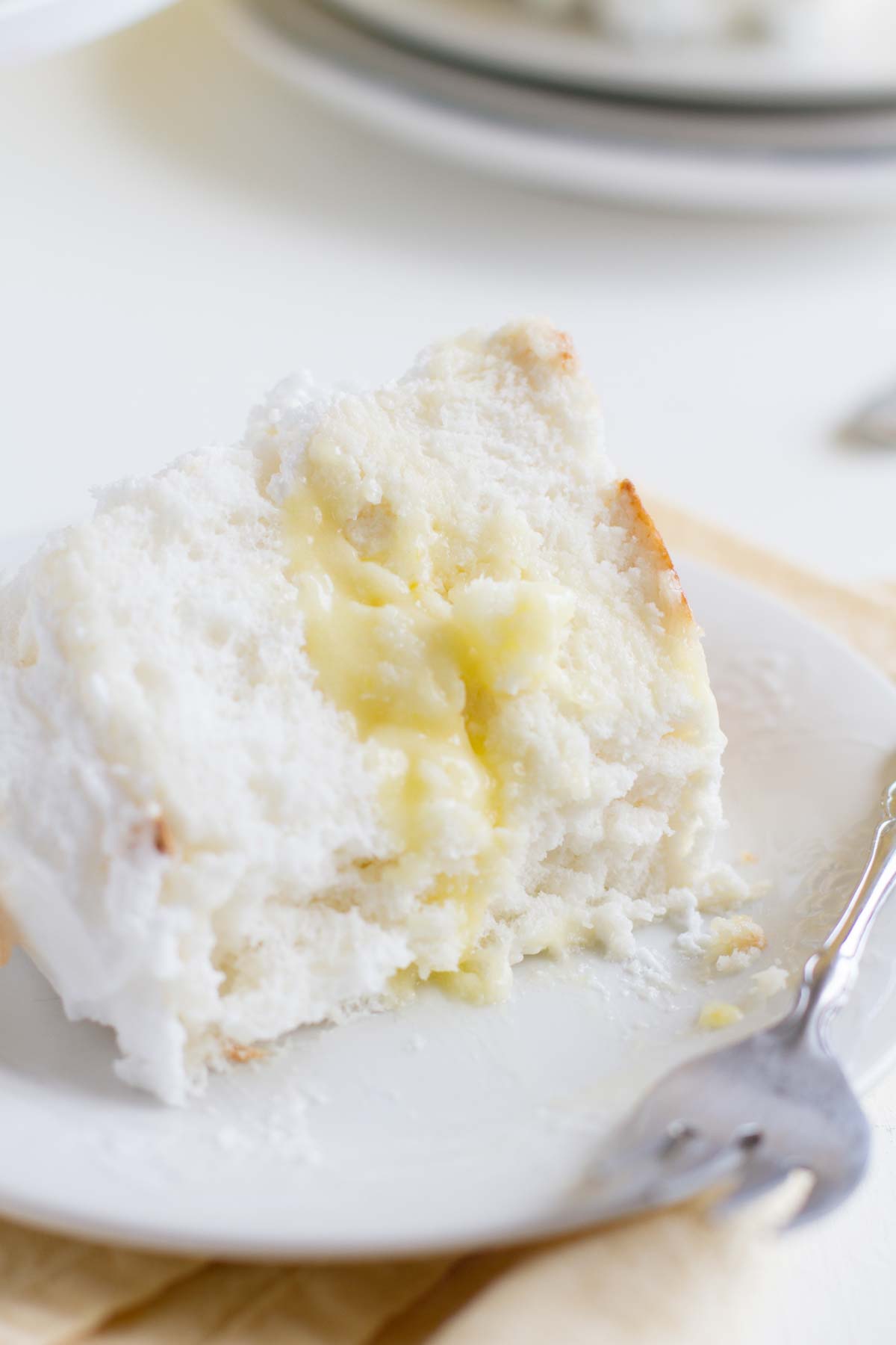 slice of Lemon Meringue Angel Cake with part eaten