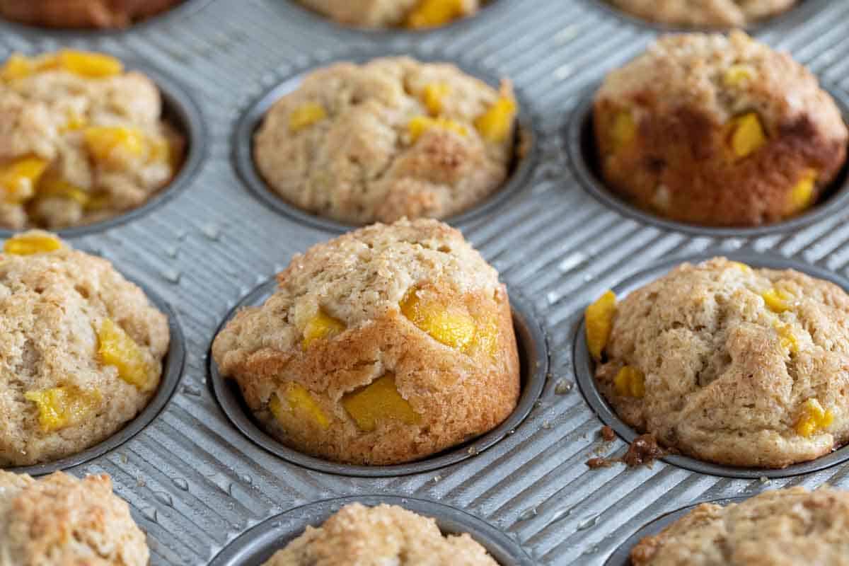 Mango muffins in a muffin tin