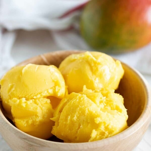 Wooden bowl with three scoops of Mango Sorbet