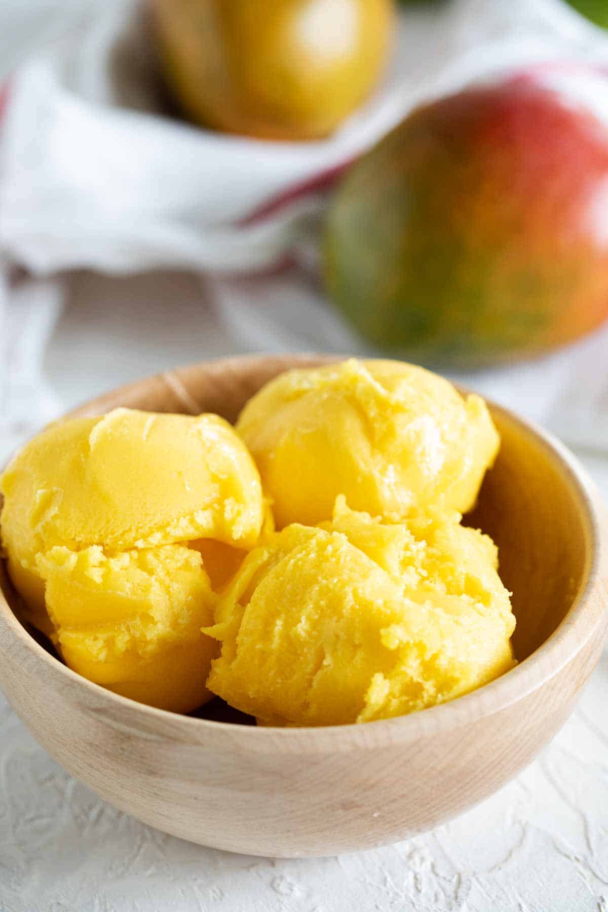 Wooden bowl with three scoops of Mango Sorbet