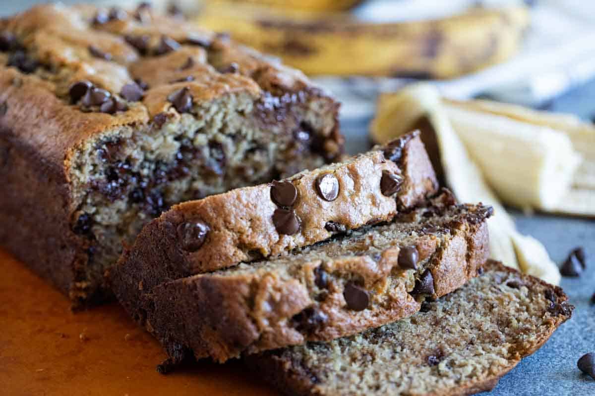 sliced loaf of Peanut Butter Banana Bread with Chocolate Chips on a cutting board