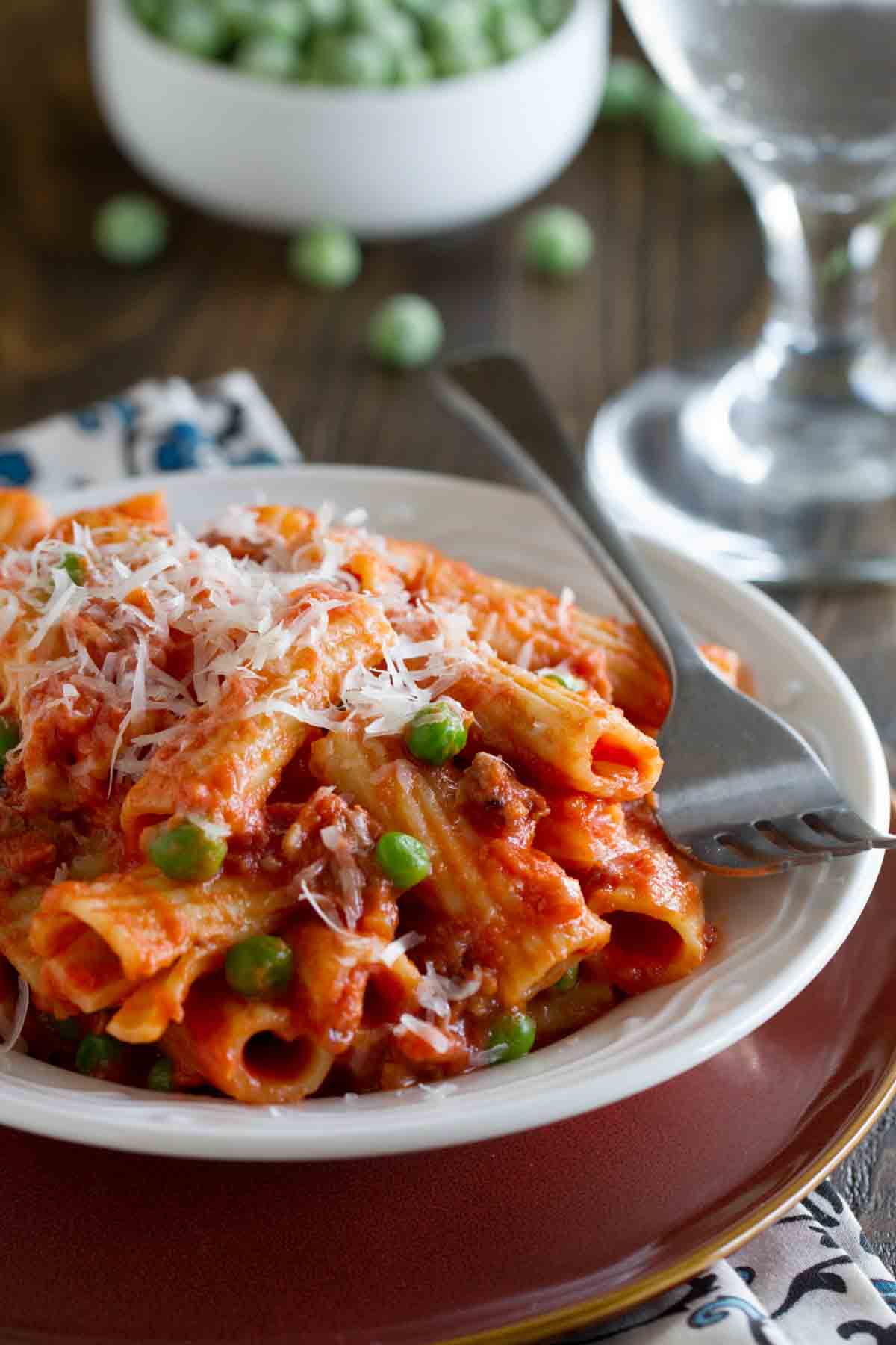 Rigatoni with Sausage, Peas, Tomatoes and Cream in a dish