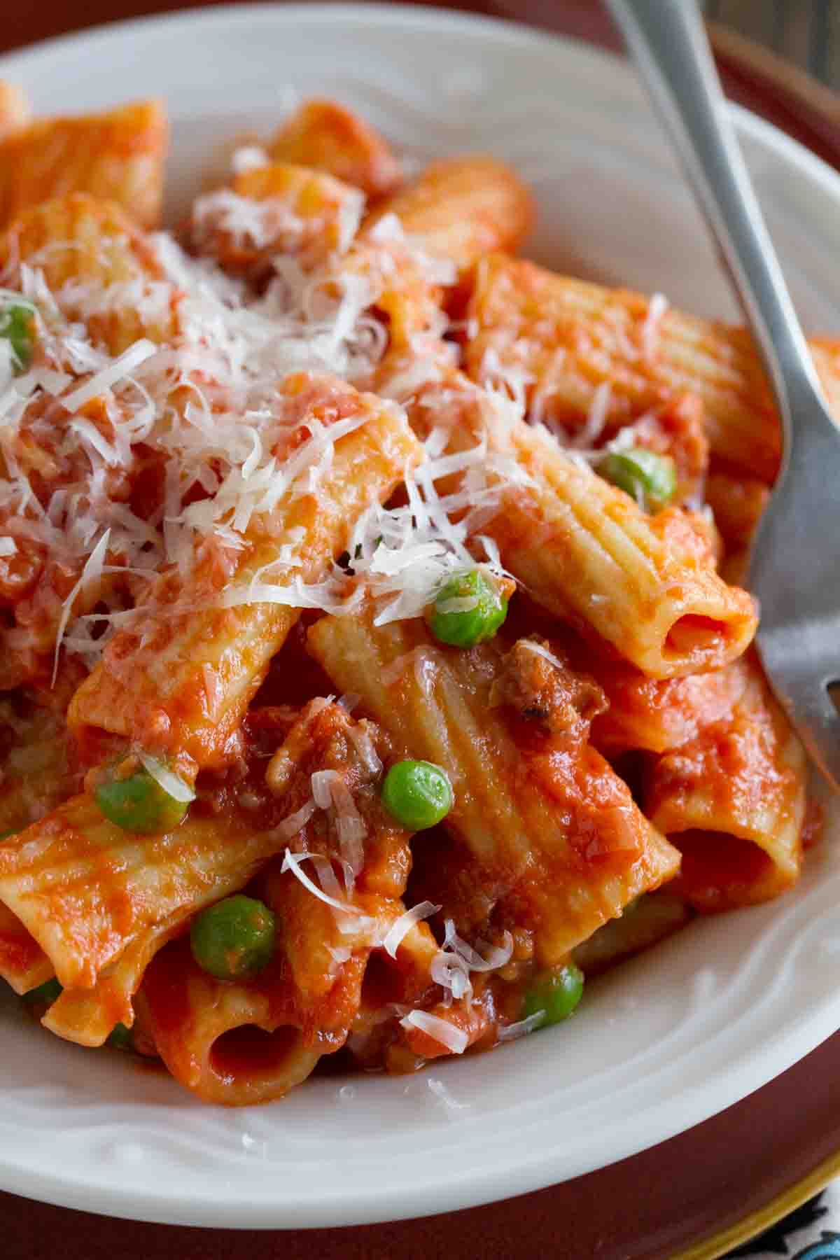 Rigatoni with Sausage, Peas, Tomatoes and Cream topped with parmesan cheese