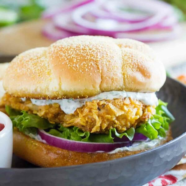 spicy chicken sandwich with cilantro lime mayo, lettuce, and red oimos