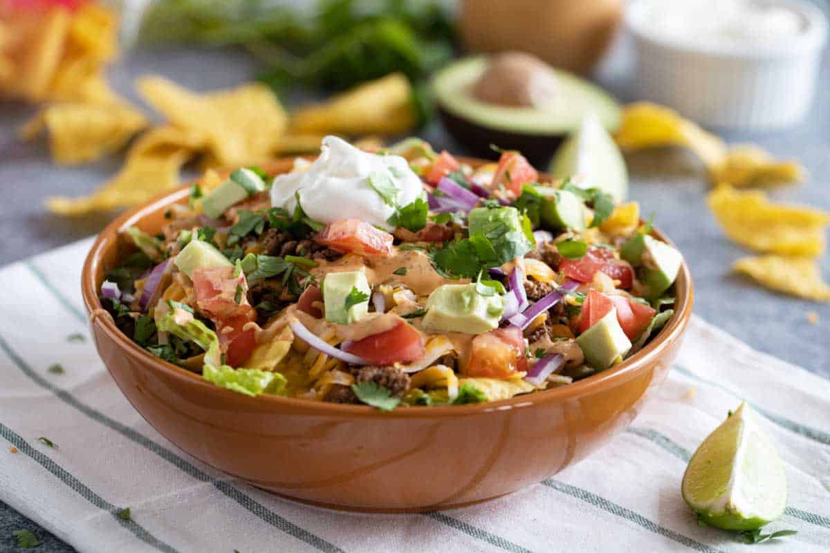 bowl filled with taco salad with lots of toppings