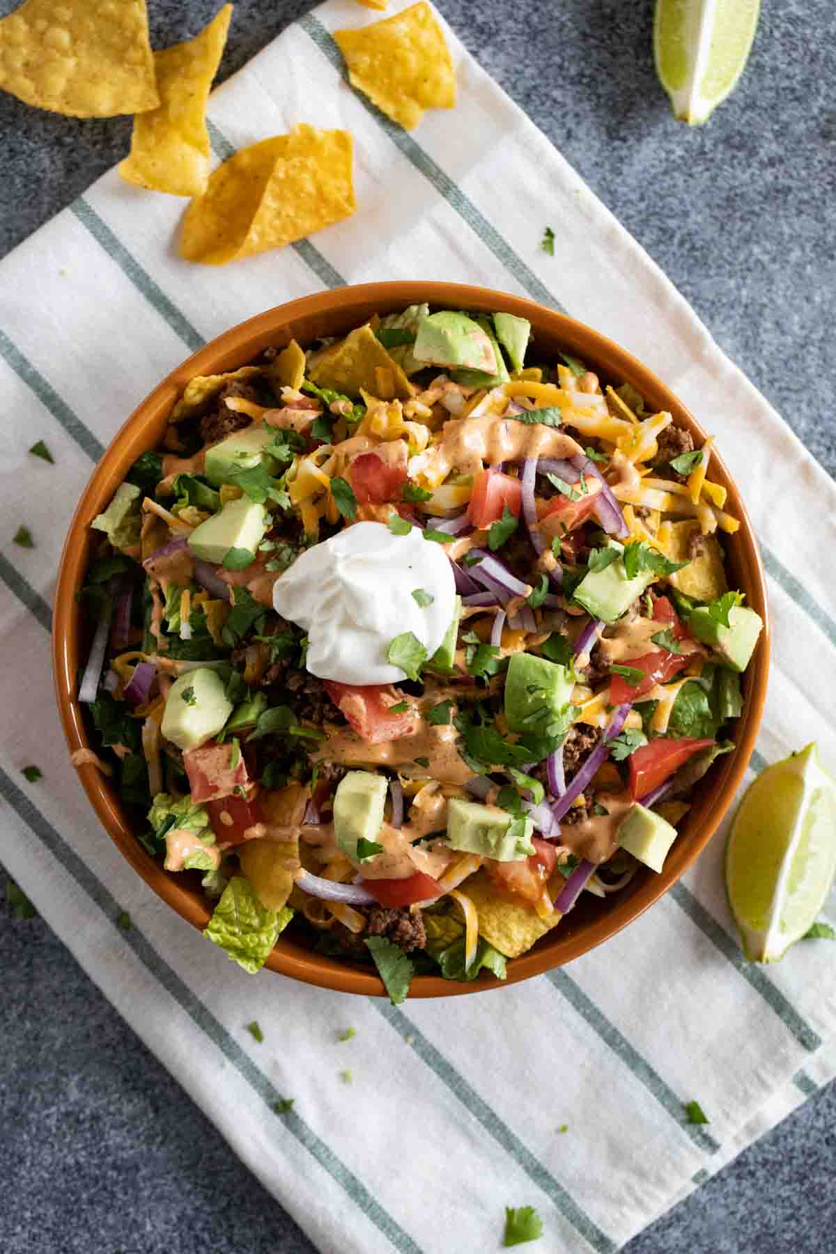 Taco Salad topped with lots of toppings and tortilla chips