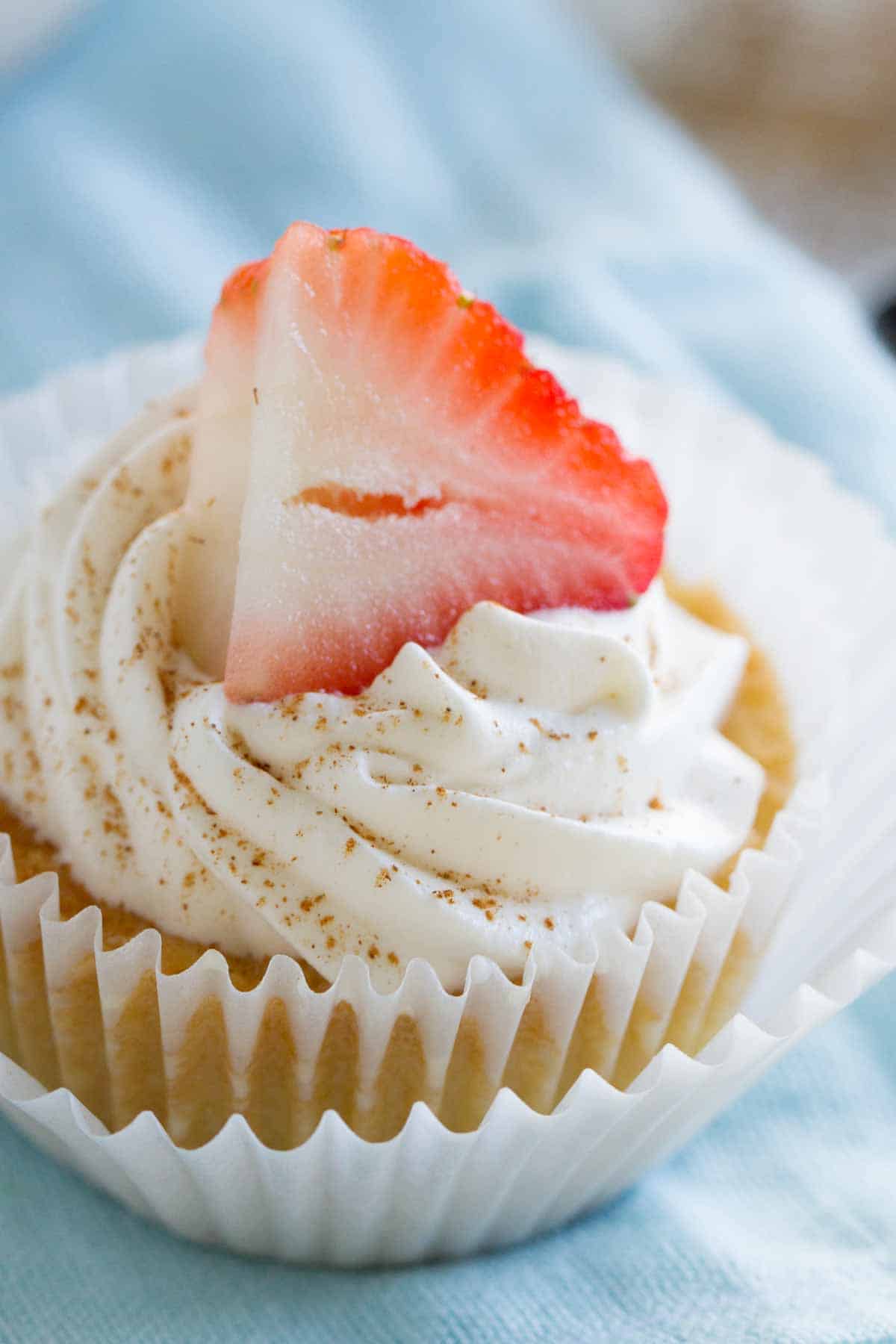 tres leches cupcake with whipped cream and cinnamon