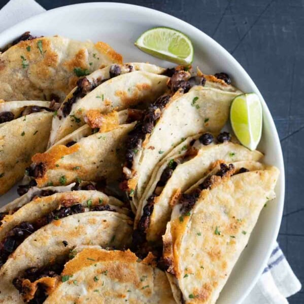 black bean tacos on a plate with lime wedges