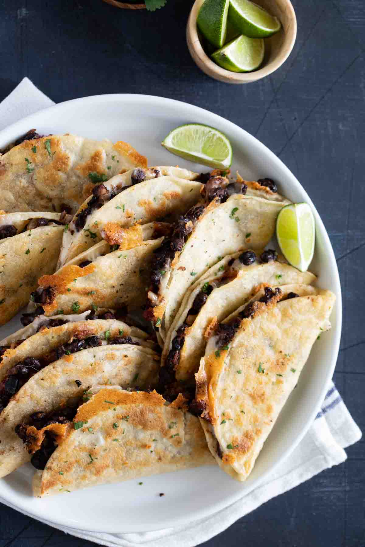 black bean tacos on a plate with lime wedges