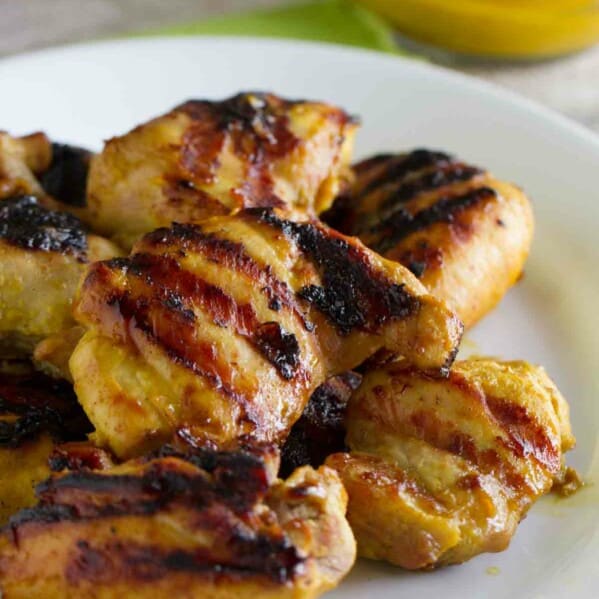 Grilled Brown Sugar Mustard Chicken stacked on a plate