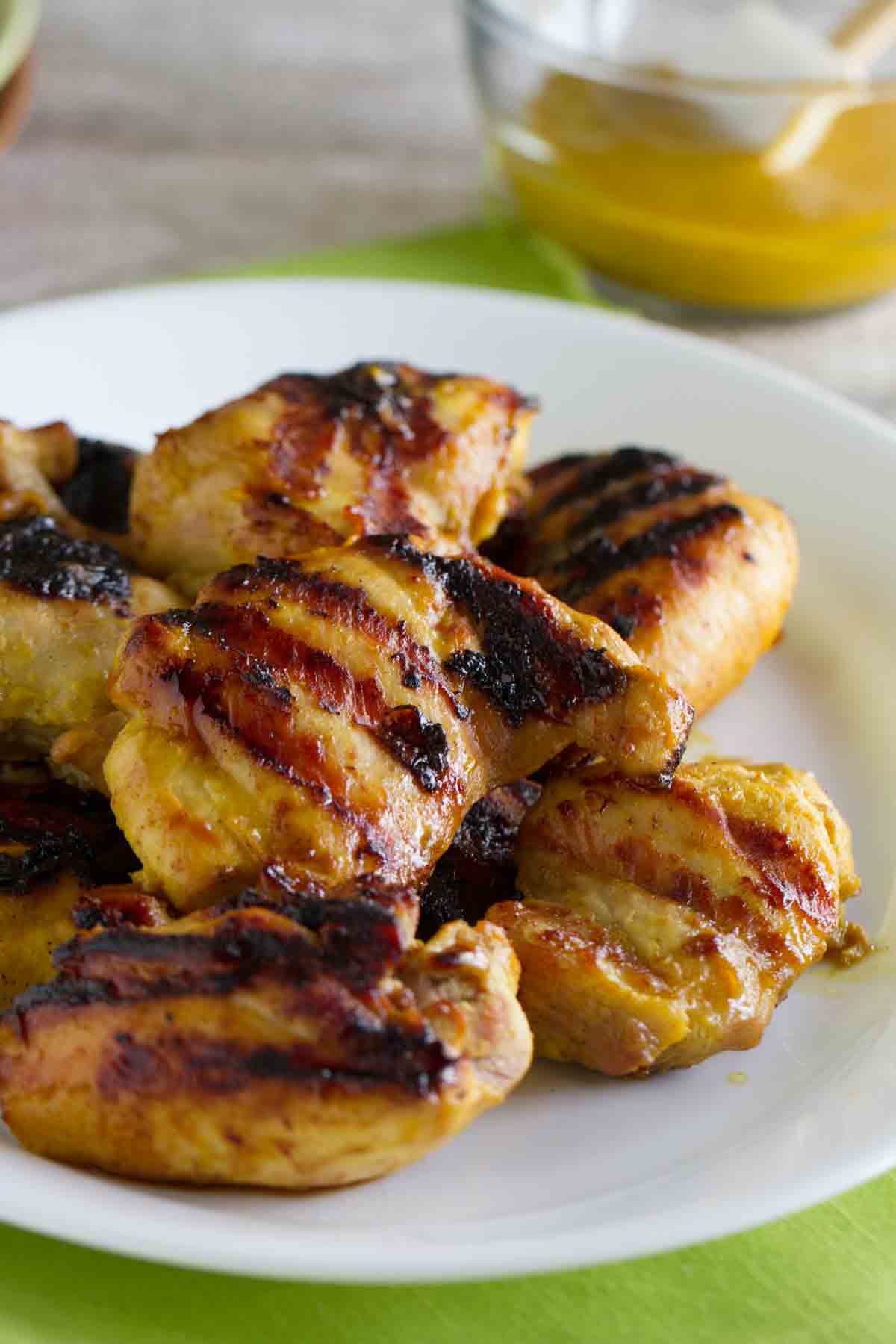 Grilled Brown Sugar Mustard Chicken stacked on a plate