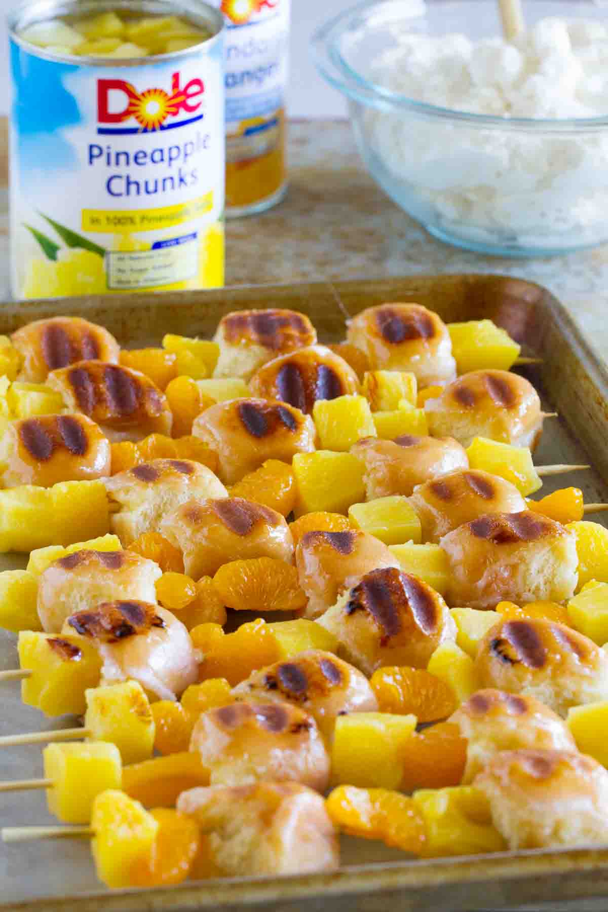 Grilled kabobs with donuts, pineapple, and oranges