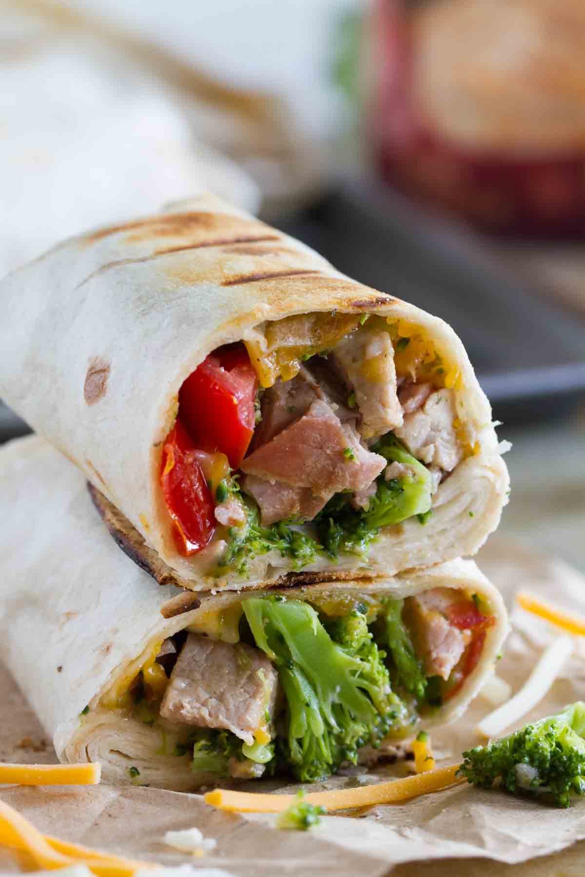 Take it to the grill! These Grilled Pork Burritos only have a few ingredients, but are not short on flavor. This is the perfect way to serve up burritos with a summer flair. Grilled Pork Burritos cut in half and stacked