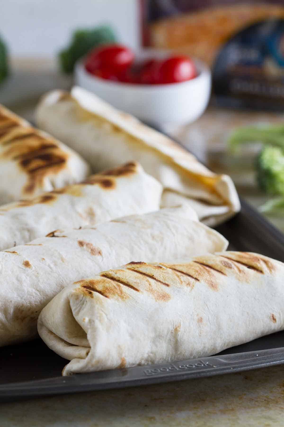 Grilled Pork Burritos on a baking sheet