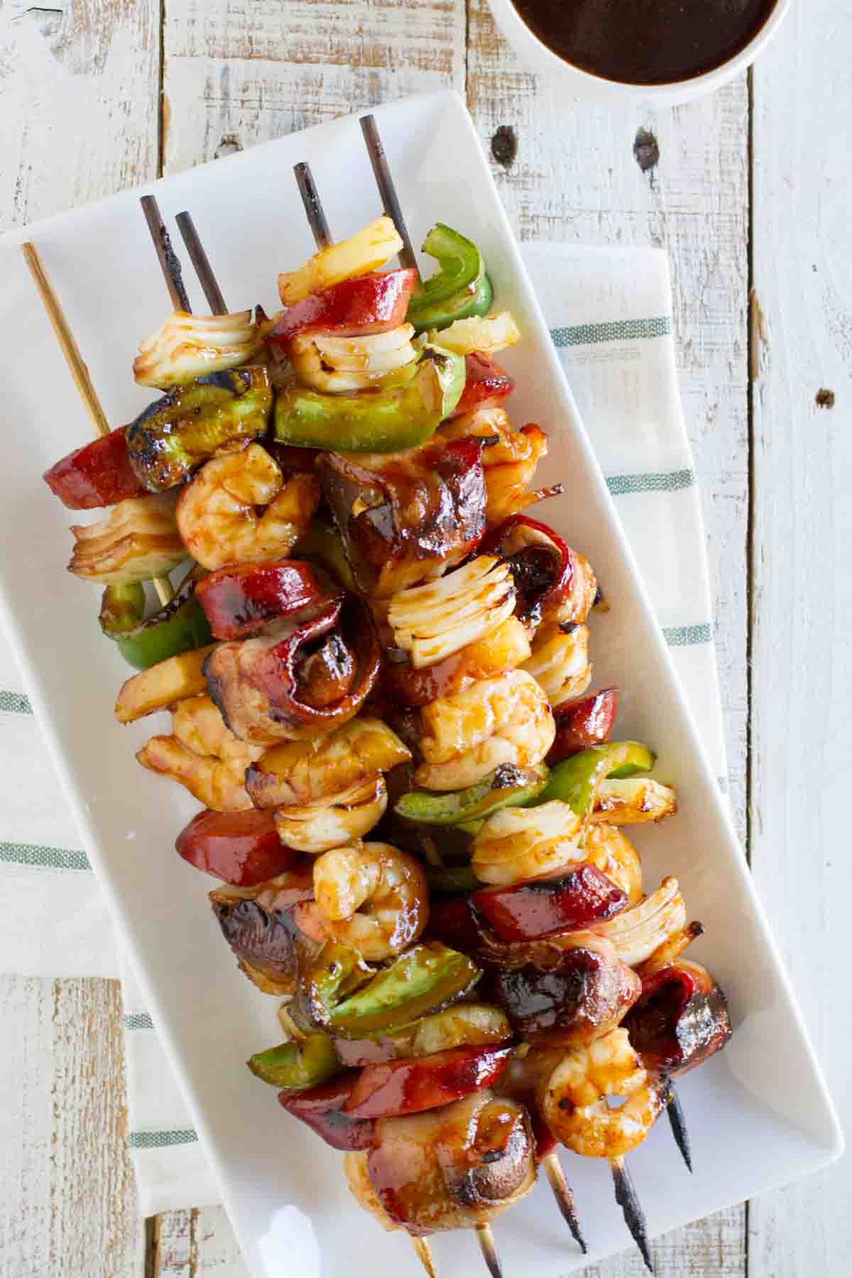 stack of grilled shrimp and sausage kabobs