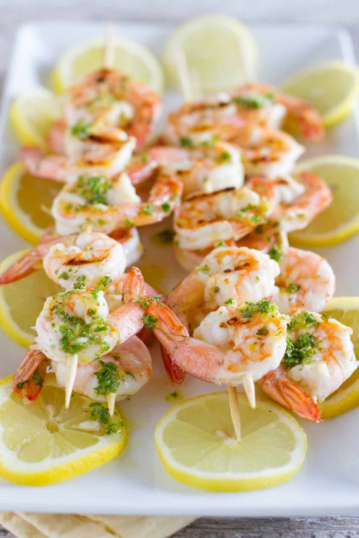 Grilled Lemon Shrimp Kabobs served over lemon slices.