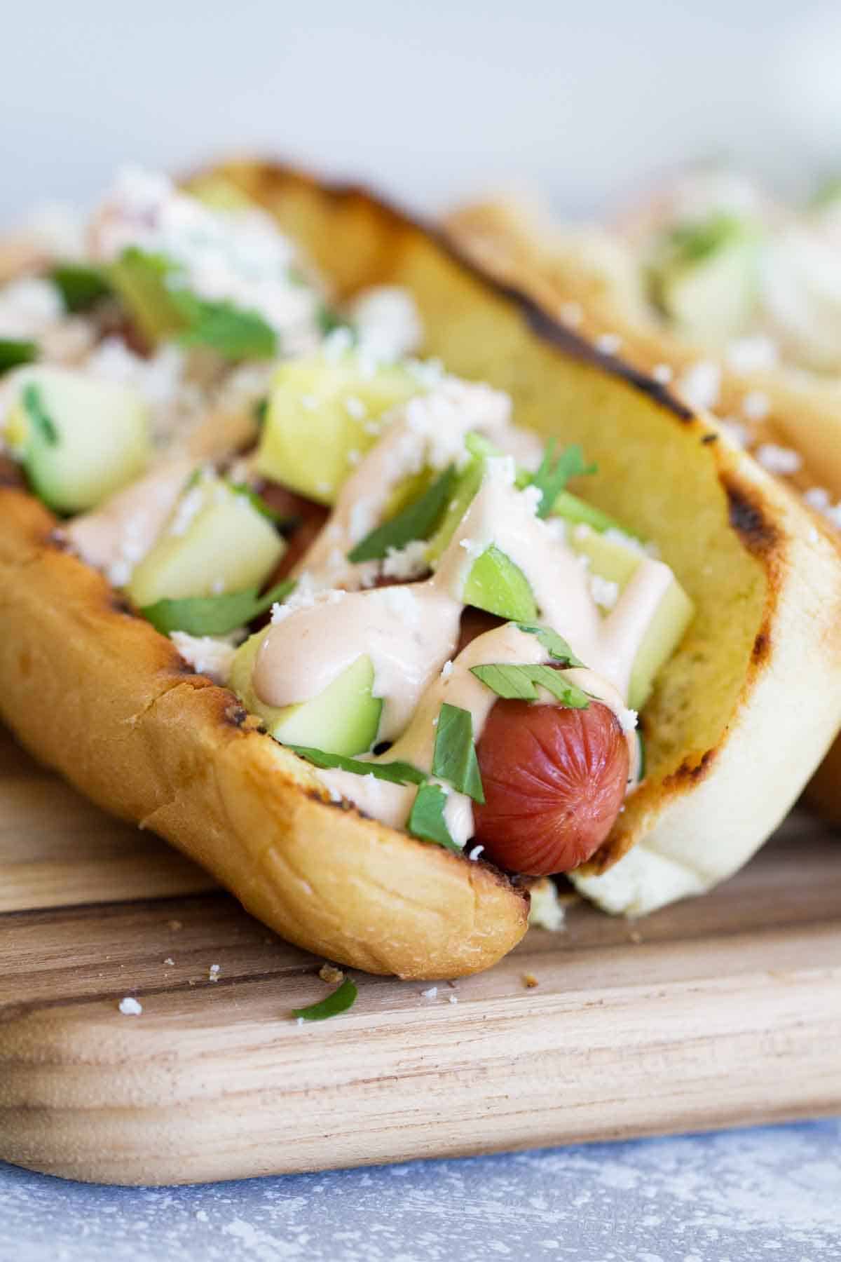 Mexican Hot Dog Recipe - hot dog topped with Mexican inspired toppings