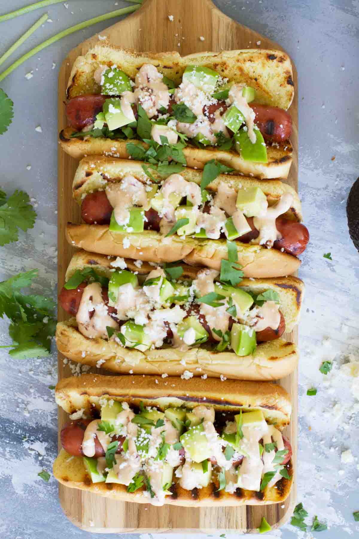 Grilled hot dogs topped with Mexican inspired toppings