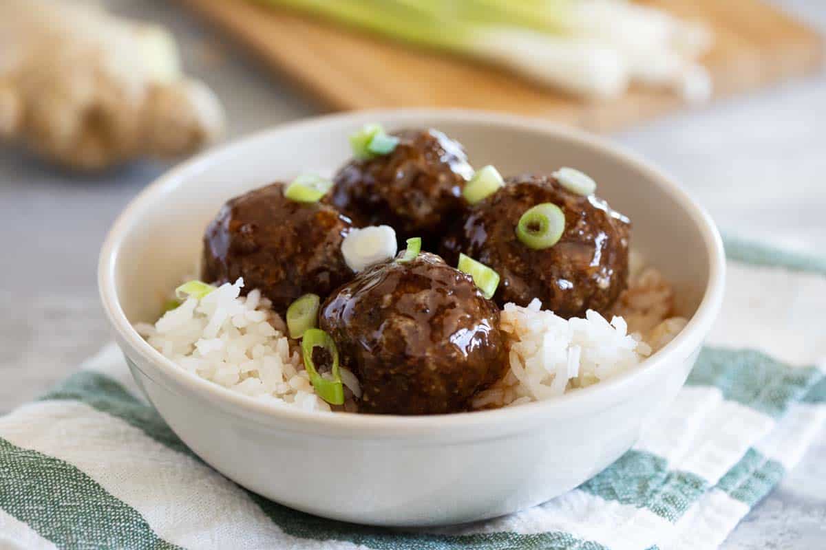 Sweet and Sour Meatballs over rice in a bowl