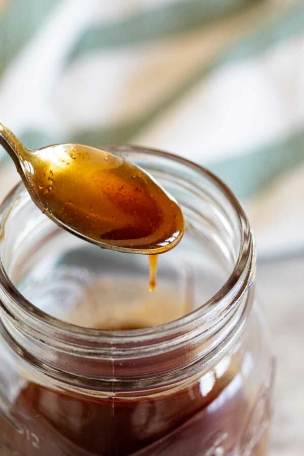spoon full of sweet and sour sauce out of a jar