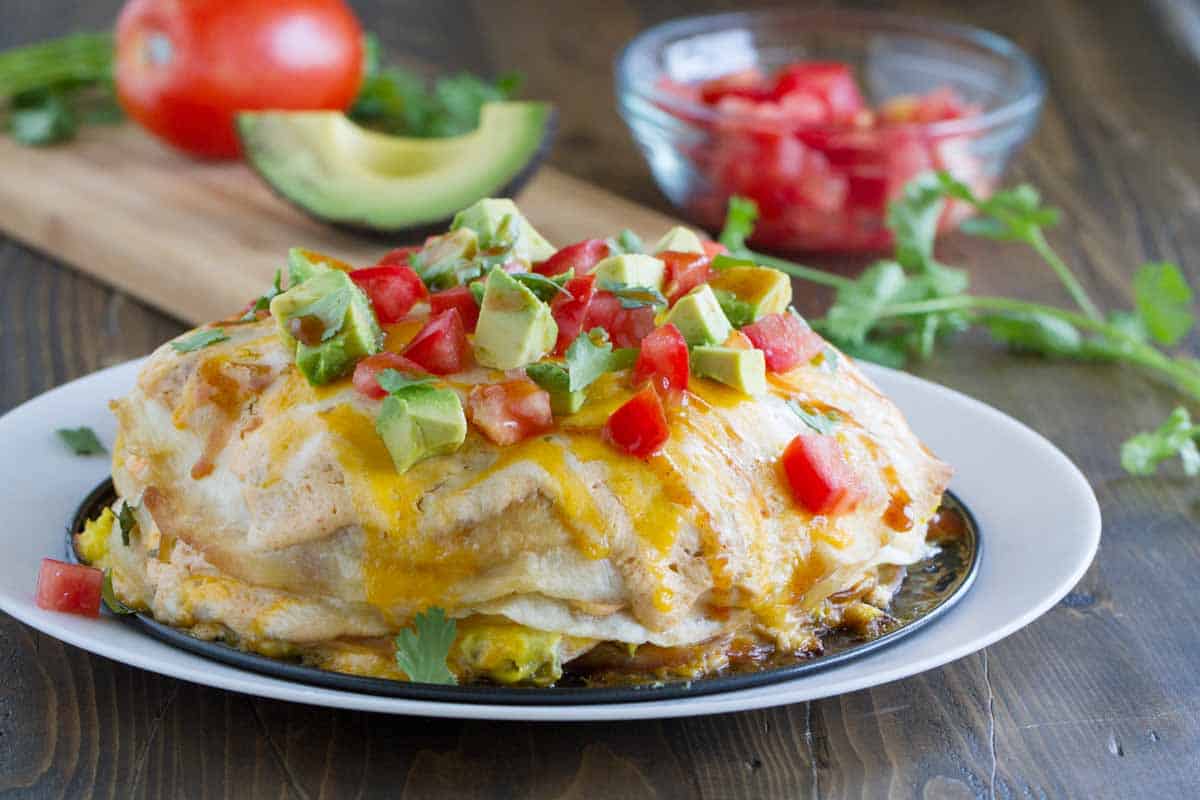 Full Breakfast Tortilla Stack topped with tomatoes and avocados