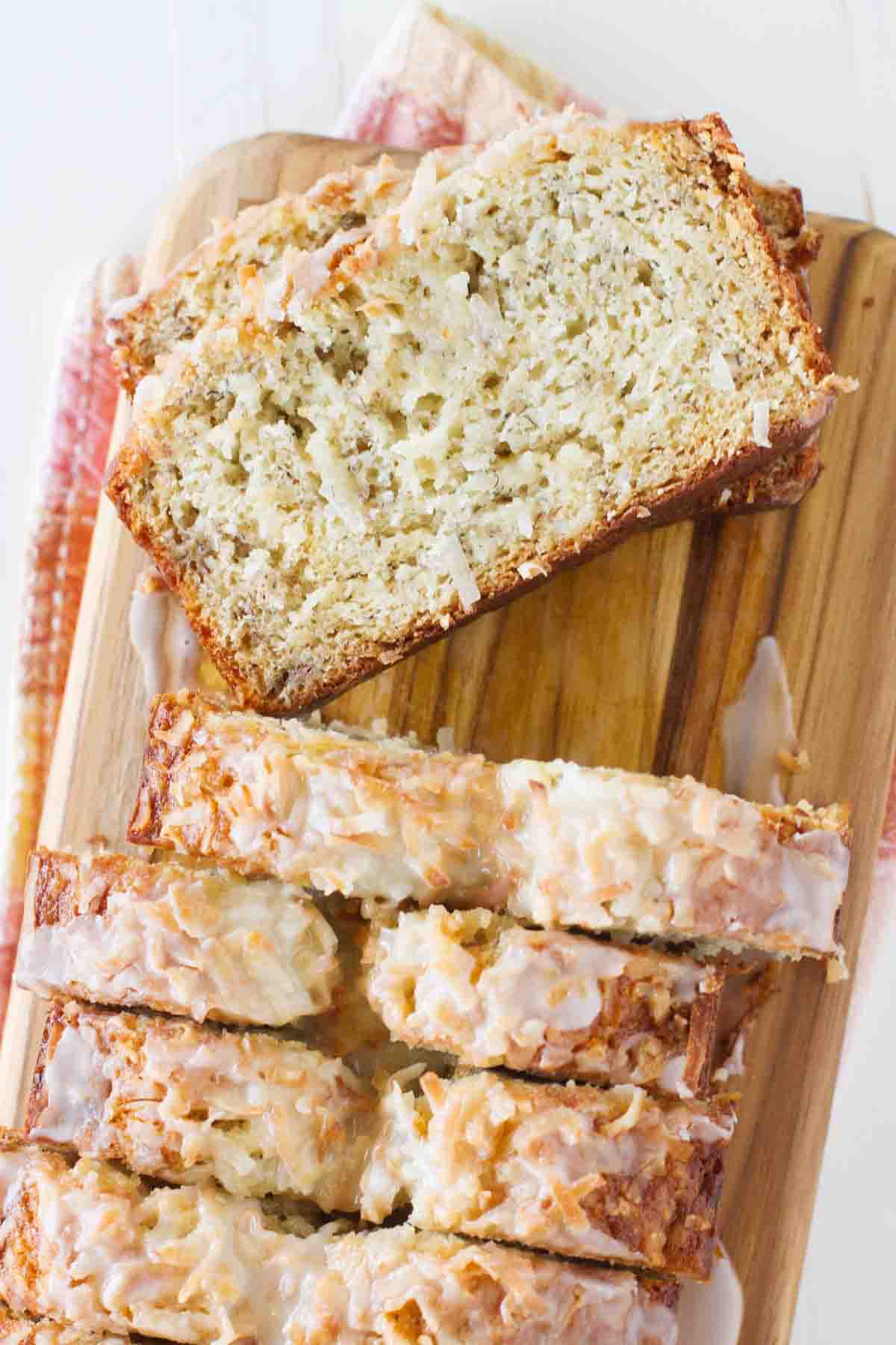 sliced loaf of Citrus Glazed Coconut Banana Bread with a slice to show texture