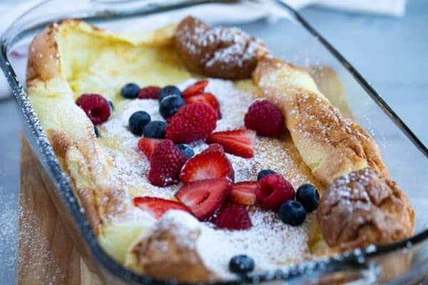 Dutch Baby (or German Pancake) topped with berries and powdered sugar
