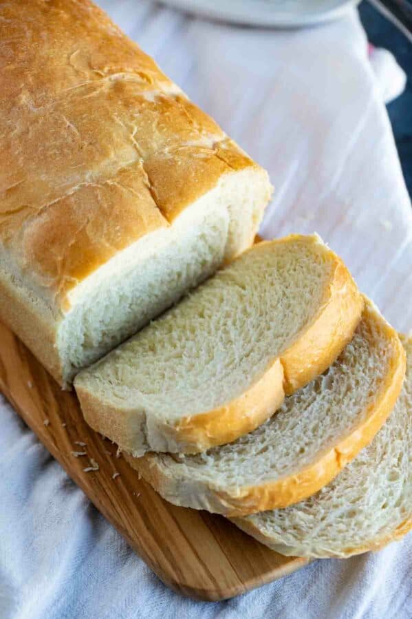 Potato bread on a cutting board with a few slices cut