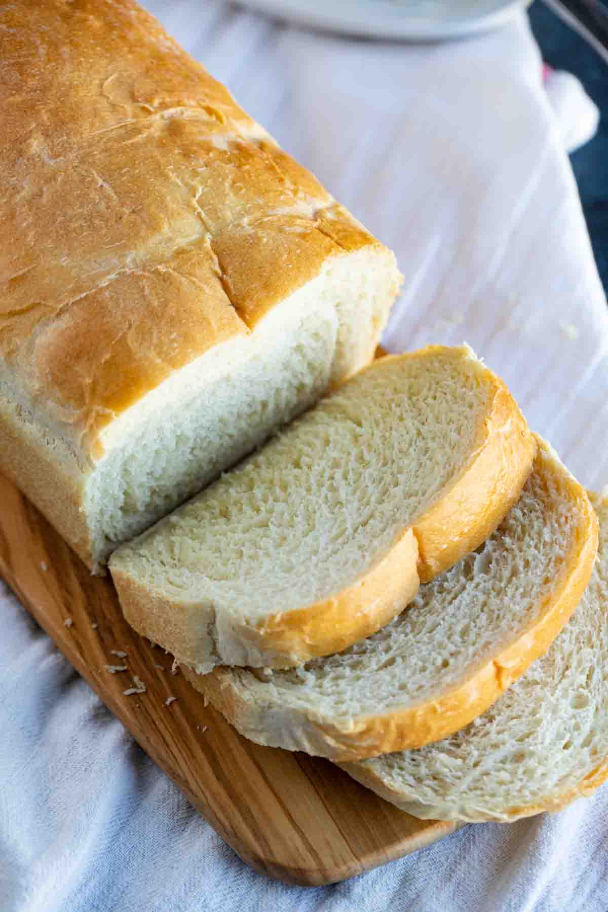 Potato bread on a cutting board with a few slices cut