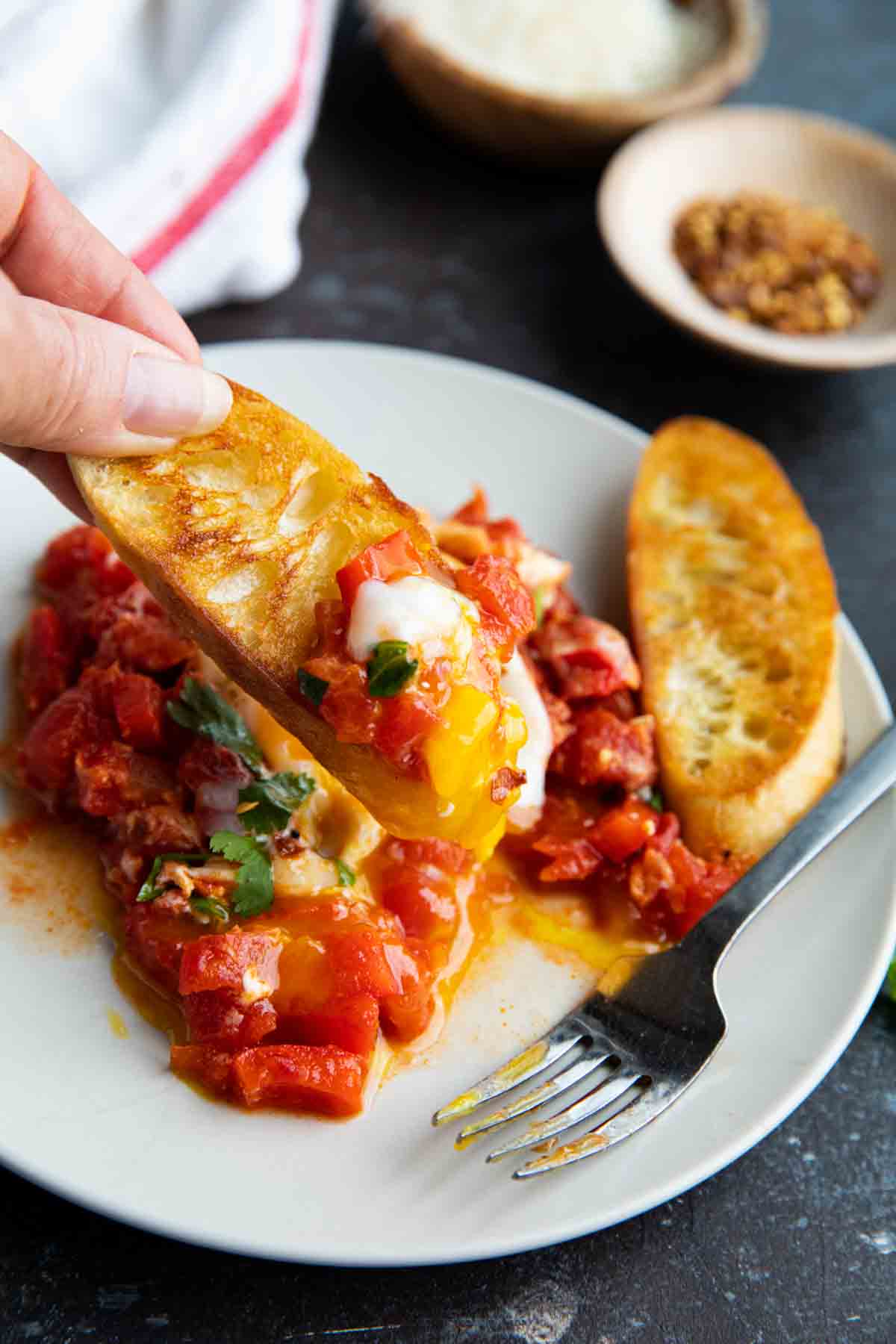 grilled bread topped with tomatoes and eggs
