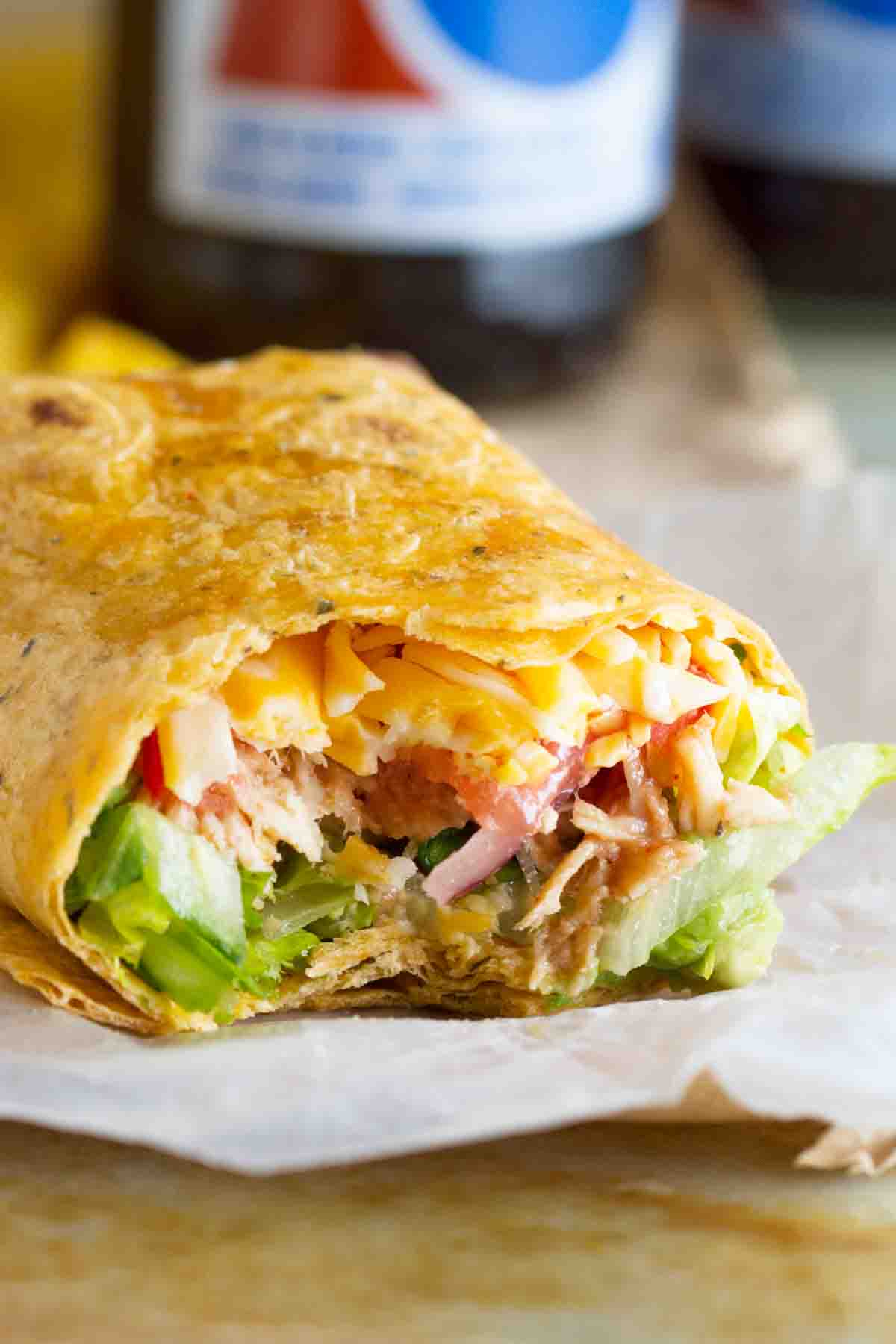 bbq chicken wrap with a bite taken from it.