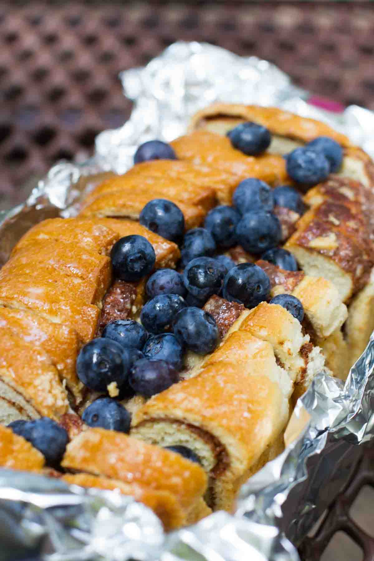 topping campfire cinnamon blueberry bread with fresh blueberries