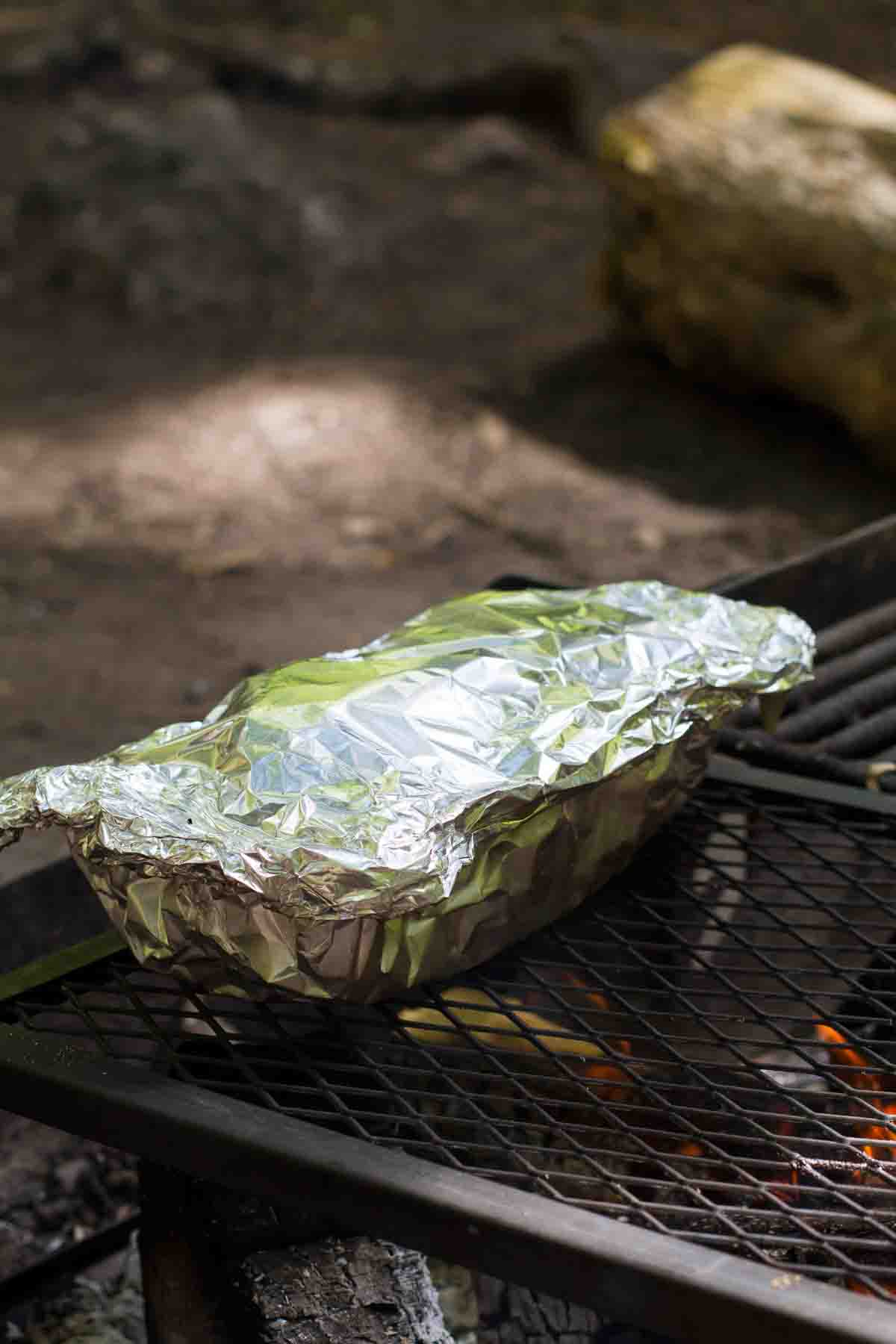 foil covered campfire cinnamon blueberry bread over a fire