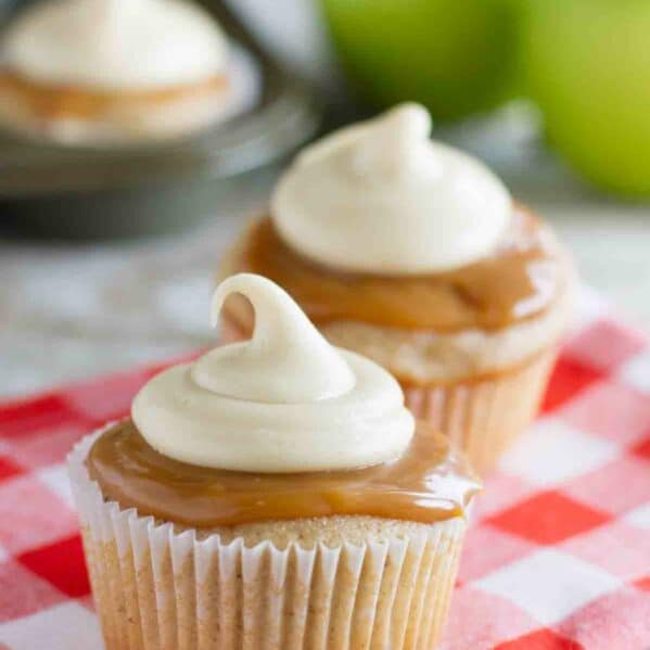 Caramel Apple Cupcakes with more cupcakes and apples in the background