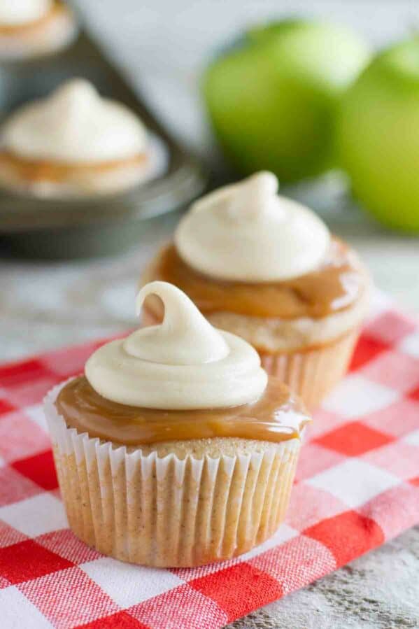 Caramel Apple Cupcakes with more cupcakes and apples in the background